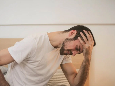 A man sitting up in bed unable to sleep