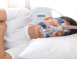 Man wearing a CPAP machine