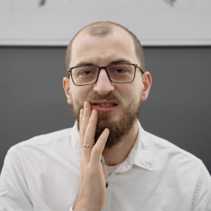 A man pressing on his cheek 