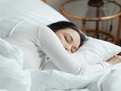 A woman sleeping soundly in bed