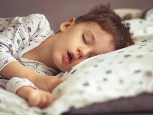 Child asleep with an open mouth, a common sign of pediatric sleep apnea